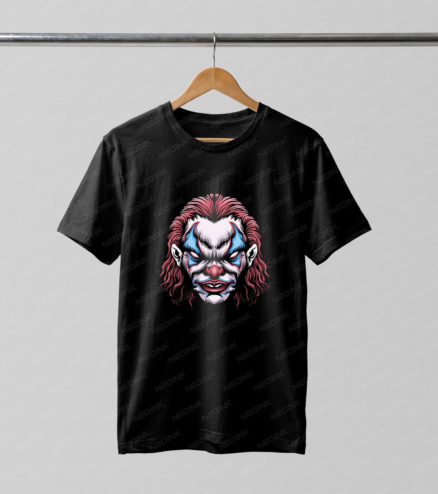 A black short-sleeve Galloween DTF transfers hanging on a wooden hanger against a light gray background. The shirt features a graphic print of a stylized clown face with messy pink hair, blue and white face paint, and red accents.