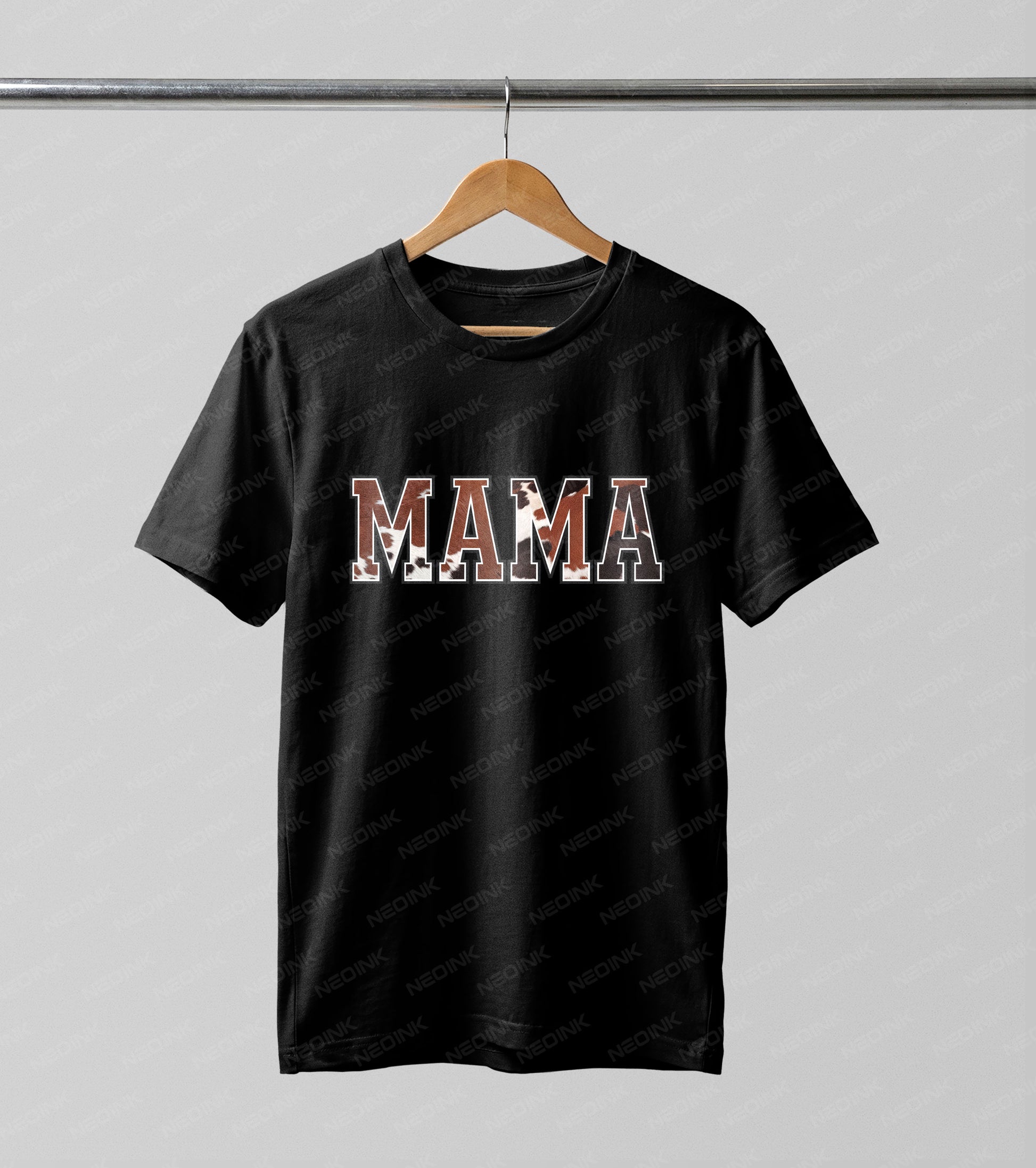 Bold "MAMA" block lettering filled with a rustic brown and white cowhide pattern, available as versatile DTF transfers that are ready to print onto stylish dark fabrics.