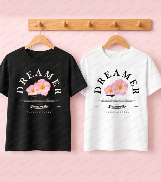 Black t-shirt featuring Dreamer typography above blooming pink flowers for a positive Good Vibes streetwear aesthetic.