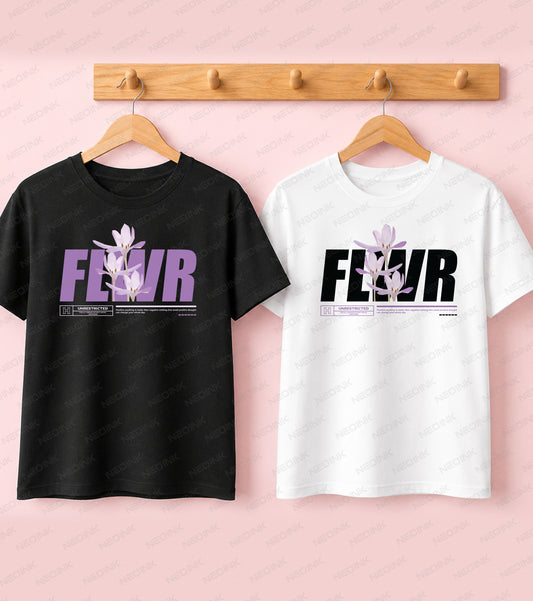 Black t-shirt with bold purple FLWR text and elegant botanical floral illustrations in a Good Vibes aesthetic.