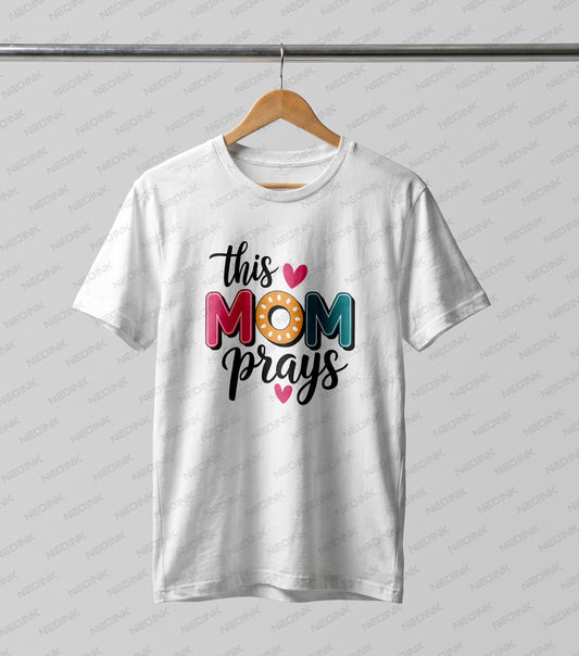 Uplifting retro lettering declaring "this MOM prays" with cute hearts, available as versatile DTF transfers ready to print for faith-based apparel.